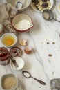 Some food making tools are placed on the white marble table