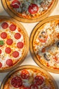 Delicious italian pizzas served on wooden table Royalty Free Stock Photo