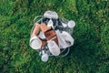 Food plastic packaging in trash bin on green moss background after picnic in forest. Top view. Recycling plastic