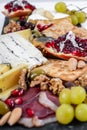 Food Platter With Truffle Cheese, Duck Breast, Brie Cheese, Pecan Nuts, Pomegranate Seeds, Grapes, Almonds, Honey, Olives Royalty Free Stock Photo