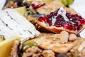 Food Platter With Truffle Cheese, Duck Breast, Brie Cheese, Pecan Nuts, Pomegranate Seeds, Grapes, Almonds, Honey, Olives Royalty Free Stock Photo