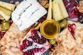 Food Platter With Truffle Cheese, Duck Breast, Brie Cheese, Pecan Nuts, Pomegranate Seeds, Grapes, Almonds, Honey, Olives Royalty Free Stock Photo