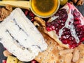 Food Platter With Truffle Cheese, Duck Breast, Brie Cheese, Pecan Nuts, Pomegranate Seeds, Grapes, Almonds, Honey, Olives Royalty Free Stock Photo