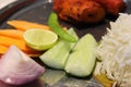 Food platter with vegetable, rice, salad, lemon, rolls, green chili etc