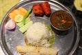 Food platter with vegetable, rice, salad, lemon, rolls, green chili etc