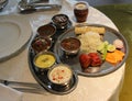 Food platter with vegetable, rice, salad, lemon, rolls, green chili etc