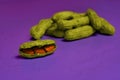 Food in pop art style. Half-open yellow peanut pod with orange grains inside on purple background and unpeeled peanuts.