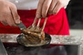 Food preparation chef cook in kitchen with pan over stove doing flambe crazy chef cooking with lamb Royalty Free Stock Photo