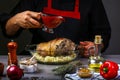 Food prepare in process pork knuckle with sharp chili sauce by chef hand in home kitchen. Dark black background with Text area for