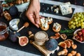 Food recipe concept. Toasts of cheese, figs and honey in hands in the kitchen. This Fig and Gorgonzola tartines, toast, bruschetta