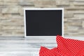 Food recipe template. Empty black board on a table with red checkered cloth against abstract blurred concrete wall. For your food Royalty Free Stock Photo