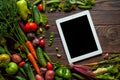 Food recipes tablet computer on rustic wooden table Royalty Free Stock Photo