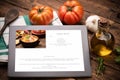 Food recipes tablet computer on rustic wooden table Royalty Free Stock Photo
