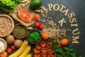 Food rich in potassium, salmon, legumes, vegetables, fruits, nuts on a dark background. Healthy food concept, avitaminosis