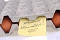 Warning legionellosis written in French on a sheet stuck to an egg carton