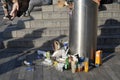 Food rubbish in and around public garbage bin in the street.