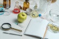 Food saferty lab. View of fresh ripe apple with test tubes and tools on table in research lab. Concept of genetic Royalty Free Stock Photo