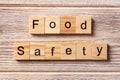 Food safety word written on wood block. Food safety text on table, concept Royalty Free Stock Photo