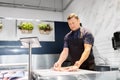 Seller weighing fish on scale at seafood shop Royalty Free Stock Photo