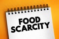 Food scarcity - lack of consistent access to enough food for every person in a household, text concept on notepad Royalty Free Stock Photo