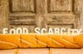 Food scarcity word on baguette Royalty Free Stock Photo