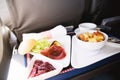 Food served on board of business class airplane on the table Royalty Free Stock Photo