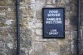 Food served families welcome sign on wall of restaurant Royalty Free Stock Photo