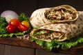 Shawarma, roll in lavash , grilled meat, with vegetables, sandwich , on a wooden brown background, horizontal, copy spase Royalty Free Stock Photo