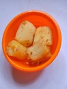 Fried cassava served in a bowl on a white base
