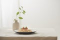 Food, spaghetti bolognese sauce in white dish and a vase of plants on a white prepared table Royalty Free Stock Photo