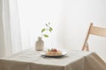 Food, spaghetti bolognese sauce in white dish and a vase of plants on a white prepared table Royalty Free Stock Photo