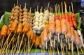 Food stall, street food at night market walking street, pile of sausages and meat balls on the wooden skewer, Bangkok, Thailand Royalty Free Stock Photo