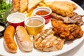 Food Steaks and Sausages Assortment Spicy Chicken, Pork, Beef, Fish served with French Fried and baked bread, sided with Royalty Free Stock Photo