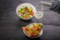 Food still life. Salad with vegetables and microgreens, canapes with pate, white wine in a glass on a dark wooden table