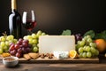 Food still life with wine, cheeses and fruits on a dark background. Royalty Free Stock Photo