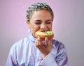 Food, studio and woman is eating a donut cake with eyes closed enjoying sweet icing and sugar pastry alone. Hungry young Royalty Free Stock Photo