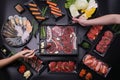 Food stylish prepare raw beef slice and seafood for barbecue japanese style, yakiniku, meat are being cooked on stove Royalty Free Stock Photo