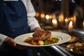 Food stylist decorating meal for restaurant presentationClose up of waiter carrying food.