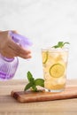 Food stylist use sprayer decorating iced tea with lemon Royalty Free Stock Photo