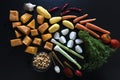 Food on a table. Cut vegetables on a black background.