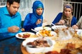 Food tastes better when you share it with family. a muslim family eating together. Royalty Free Stock Photo