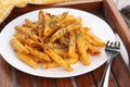 Food - Tasty Penne Pasta Plate with a Fork on Wooden Tray Royalty Free Stock Photo