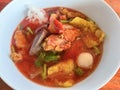 Food Thai style noodle with assorted tofu and fish ball in red soup - Asian food style pink seafood flat noodles on soup bowl Royalty Free Stock Photo