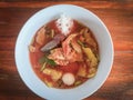 Food Thai style noodle with assorted tofu and fish ball in red soup - Asian food style pink seafood flat noodles on soup bowl Royalty Free Stock Photo