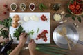 Food top view, hands cutting celery on white chopping board in kitchen wooden top work