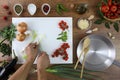 Food top view, hands cutting green onion on white chopping board Royalty Free Stock Photo