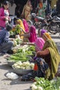 Food trader selling vegetables in street market. Pushkar, Rajasthan, India