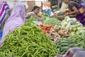 Food trader selling vegetables in street market. Udaipur, Rajasthan, India
