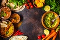 Food traditional Indian cuisine. Dal, palak paneer, curry, rice, chapati, chutney in wooden bowls on dark background Royalty Free Stock Photo