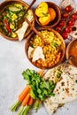 Food traditional Indian cuisine. Dal, palak paneer, curry, rice, chapati, chutney in wooden bowls on white background Royalty Free Stock Photo